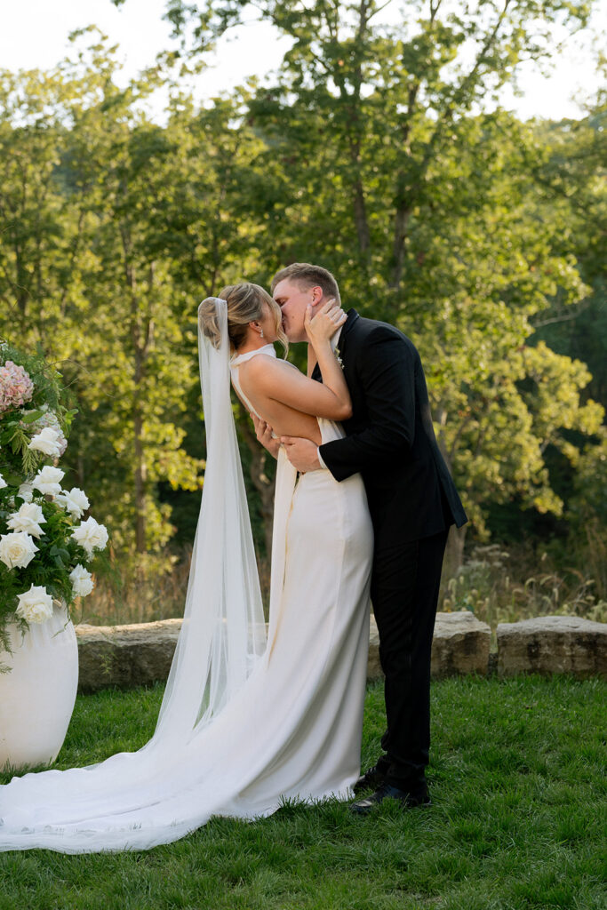 bride and groom kissing after their wedding ceremony