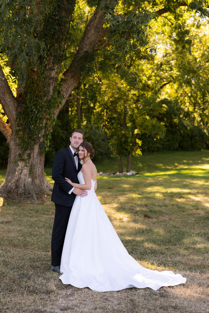 portrait of the bride and groom hugging at their dream winery wedding 