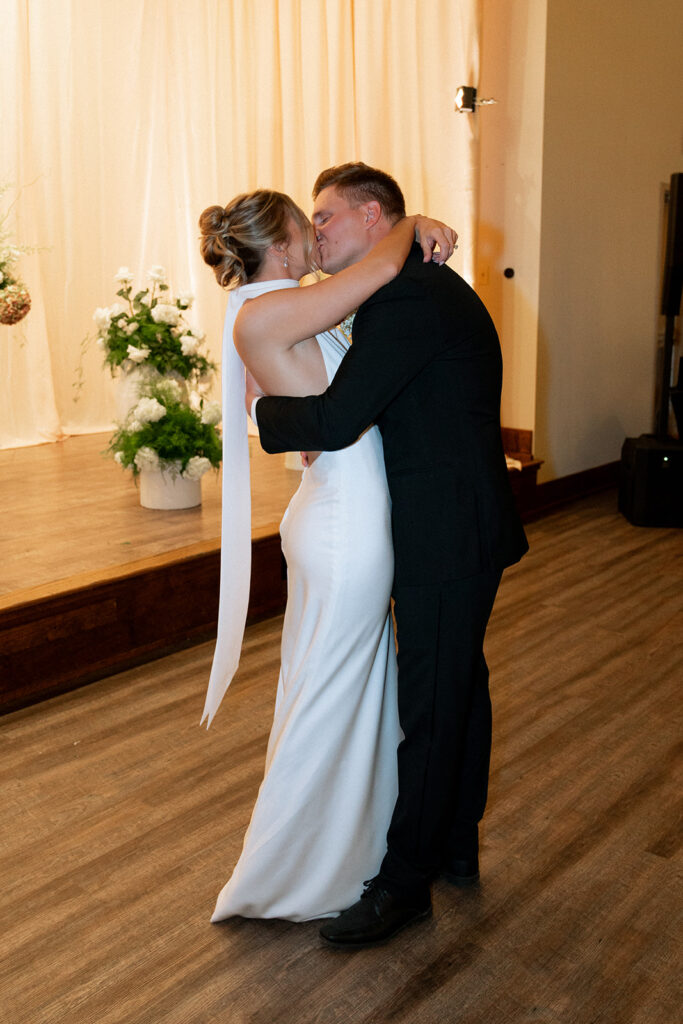 cute couple kissing after their first dance