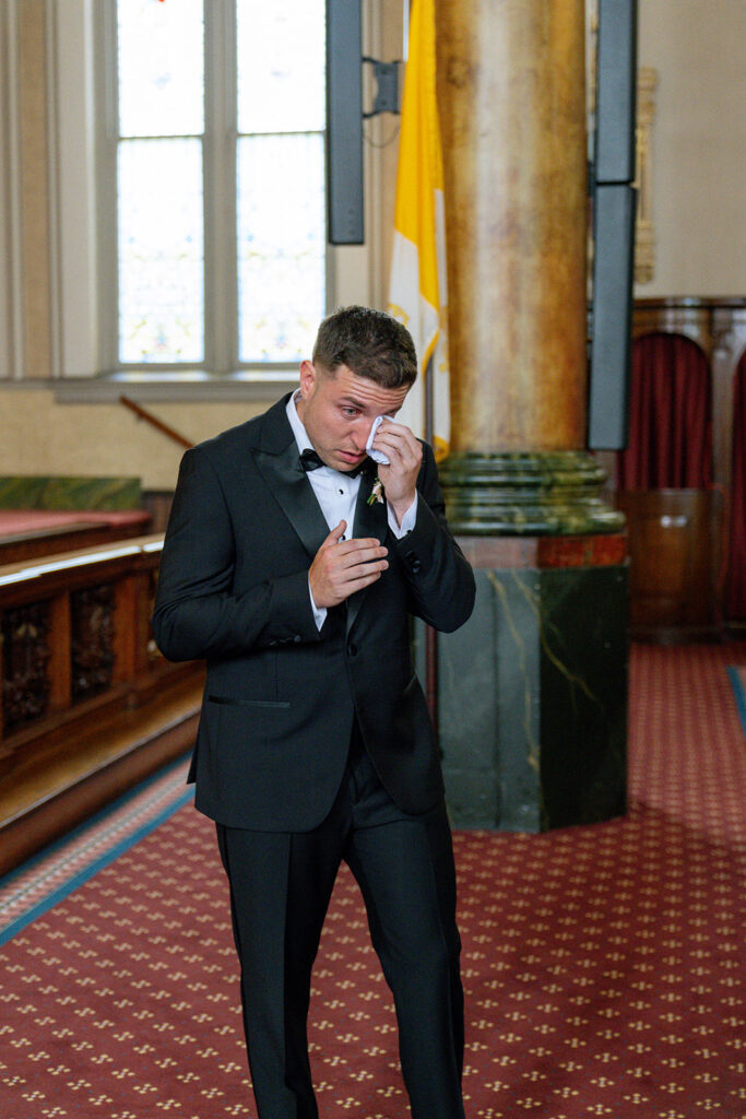 groom emotional seeing the bride walk down the aisle