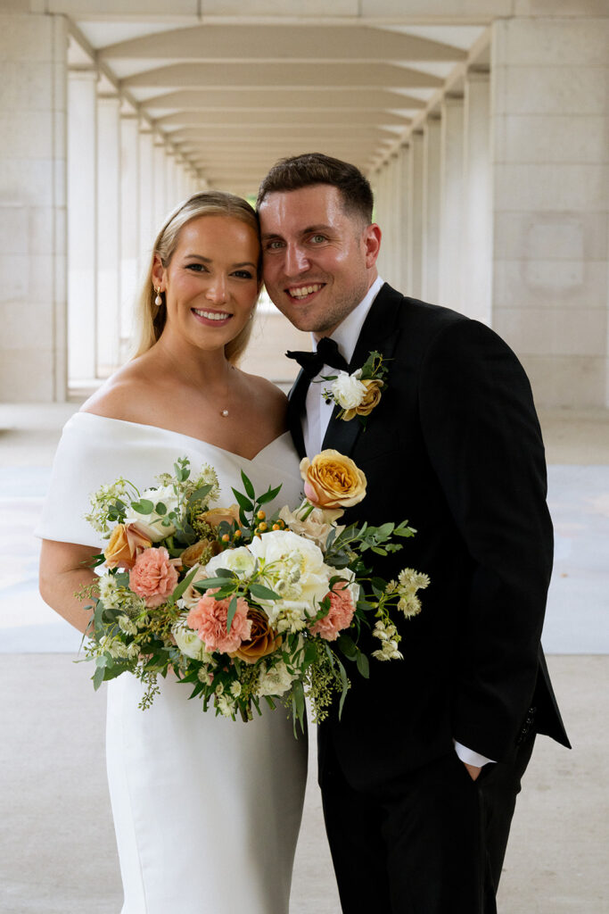 portrait of the bride and groom looking at the camera