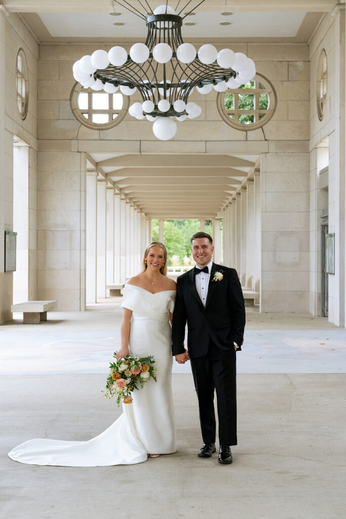 cute portrait of the newlyweds holding hands