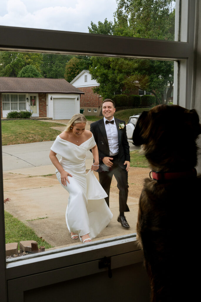 newlyweds visiting their dog before heading to the reception