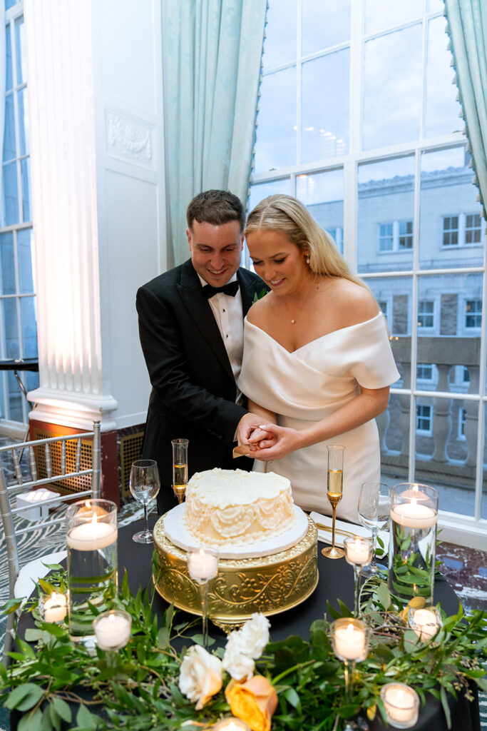 bride and groom cutting their wedding cake 