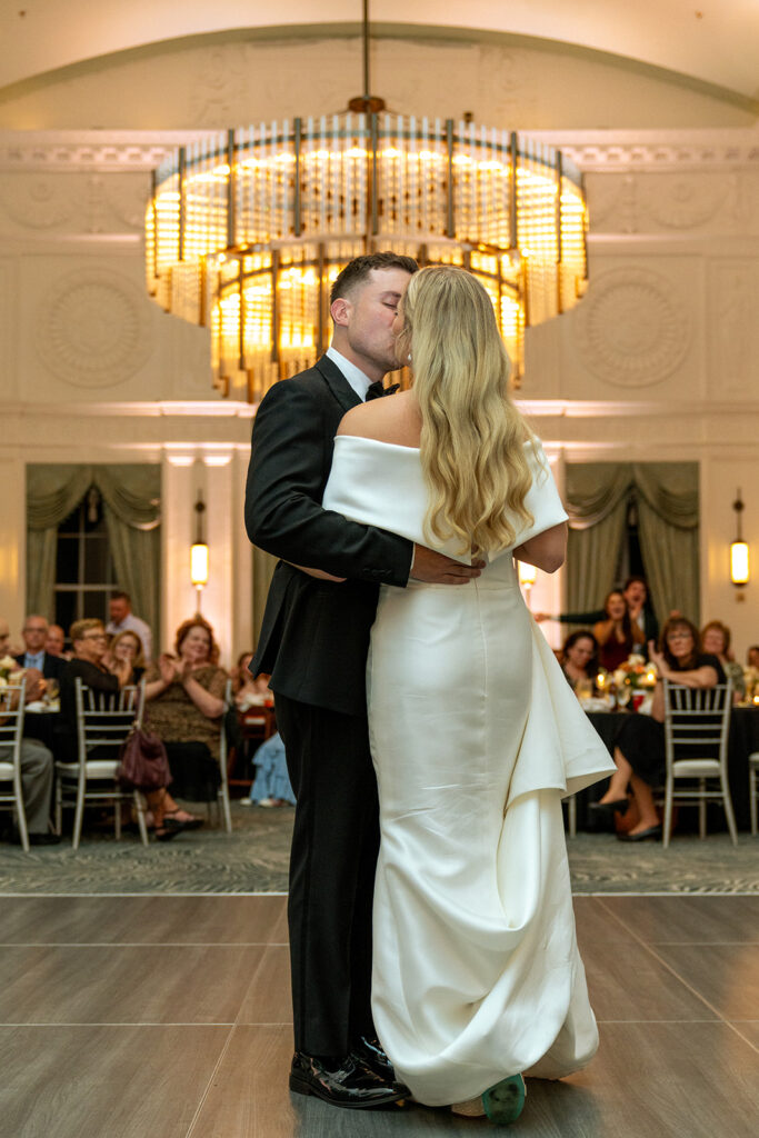 newlyweds kissing after their first dance 