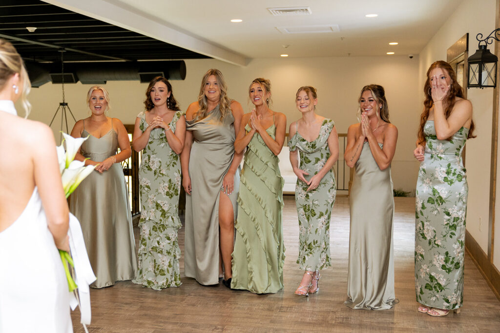 bridesmaids emotional seeing the bride in her wedding dress