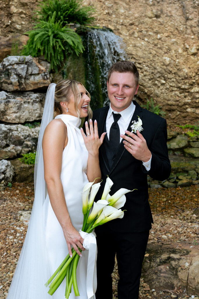 fun picture of the bride and groom showing their wedding rings