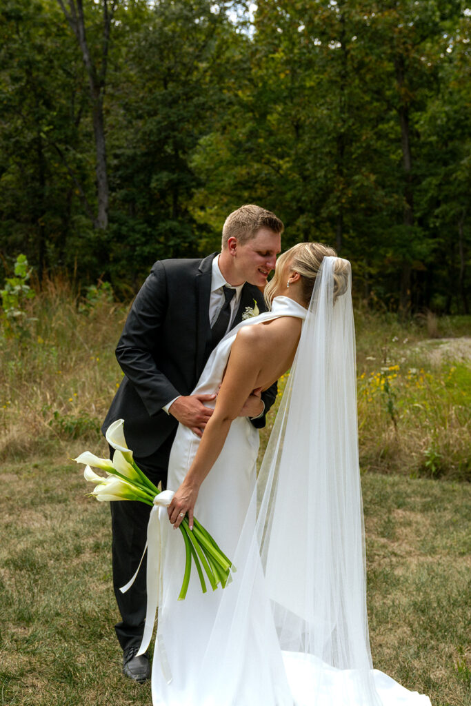 picture of the bride and groom kissing 