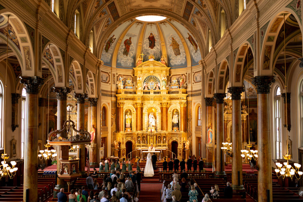 bride and groom holding hands at the altar 