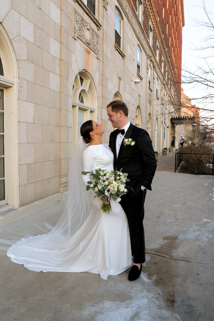 cute portrait of the bride and groom looking at each other 