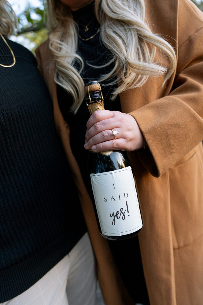 couple celebrating their engagement with champagne 