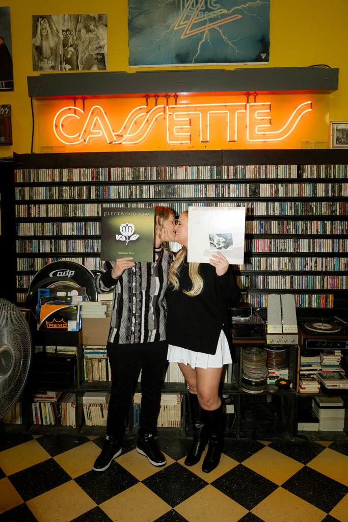 cute couple kissing at the record shop in st. louis during their engagement