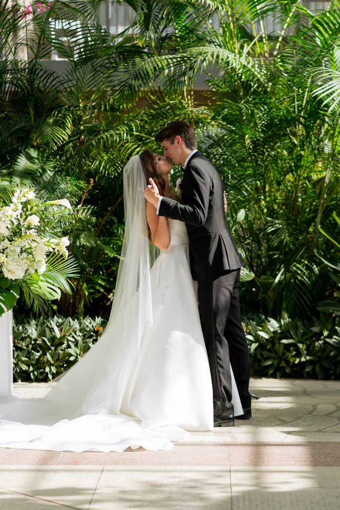 bride and groom kissing after their ceremony