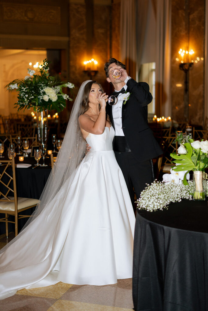 couple having a glass of champagne at their reception