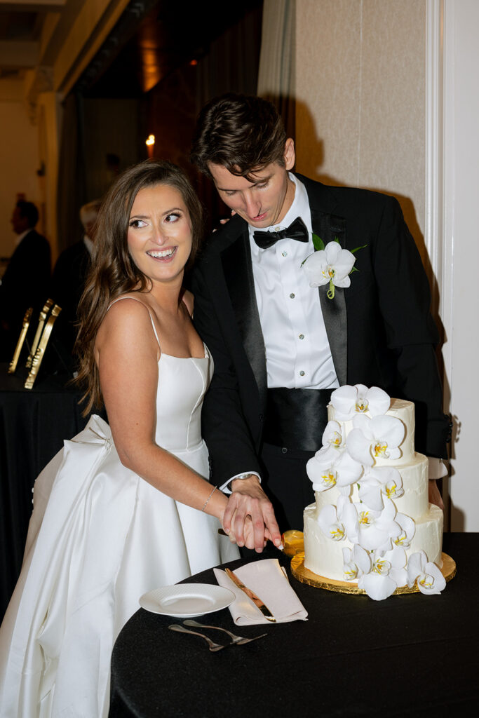 newlyweds cutting their wedding cake 