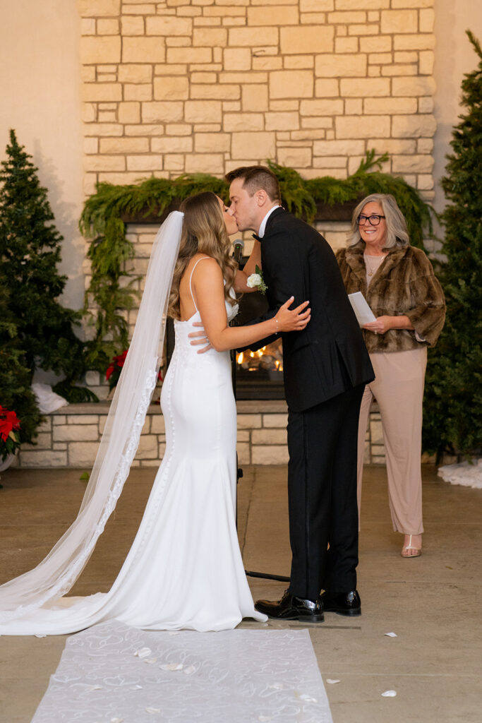cute portrait of the newlyweds kissing after their ceremony