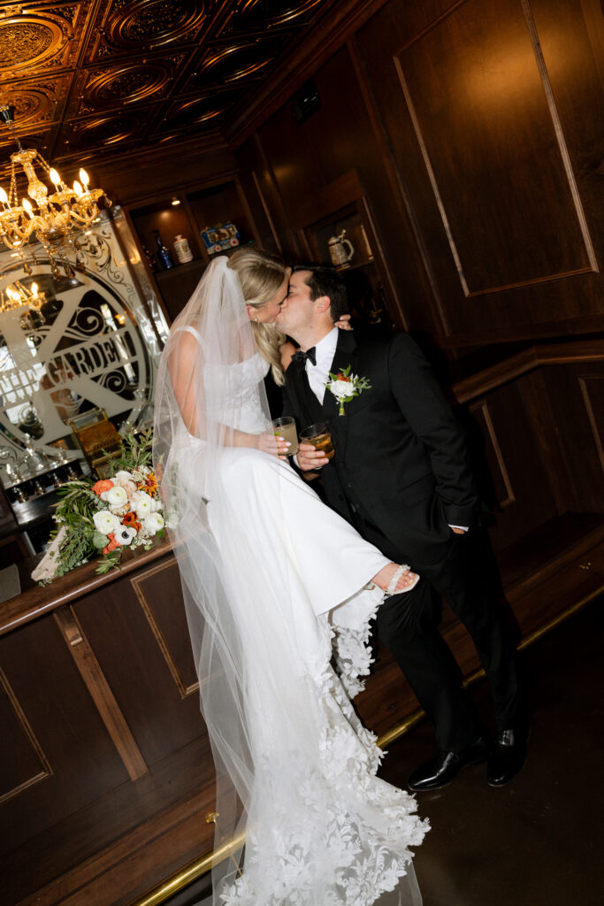 cute picture of the bride and groom kissing before heading to their reception party