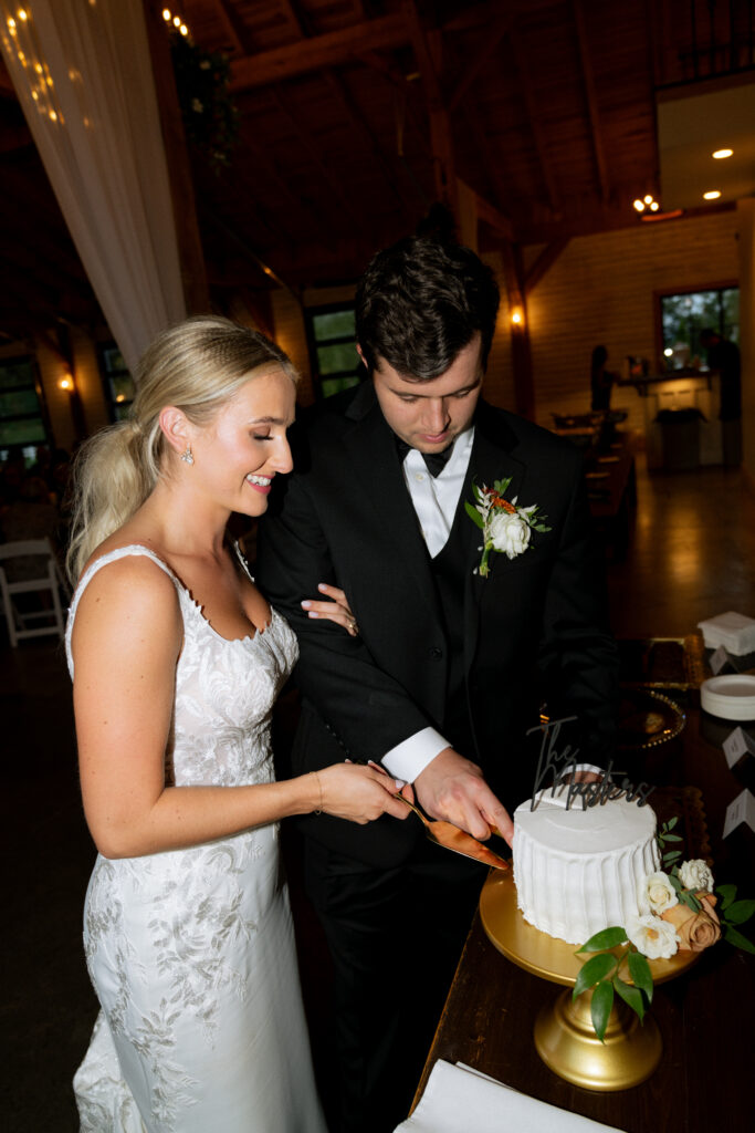 bride and groom cutting their wedding cake 