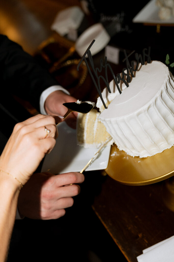 newlyweds trying their wedding cake at their reception