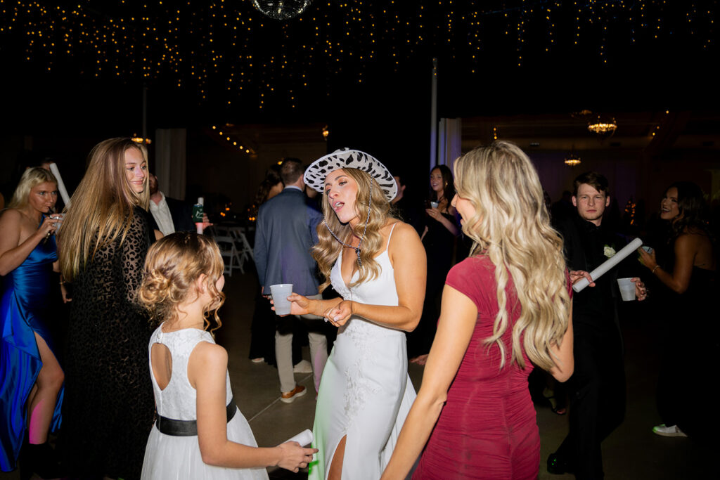 cute picture of the bride dancing with her guests at the reception party