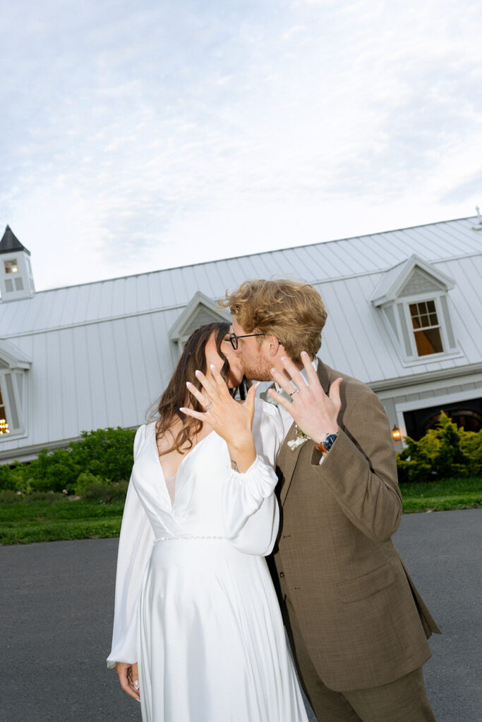 fun portrait of the bride and groom showing their wedding rings