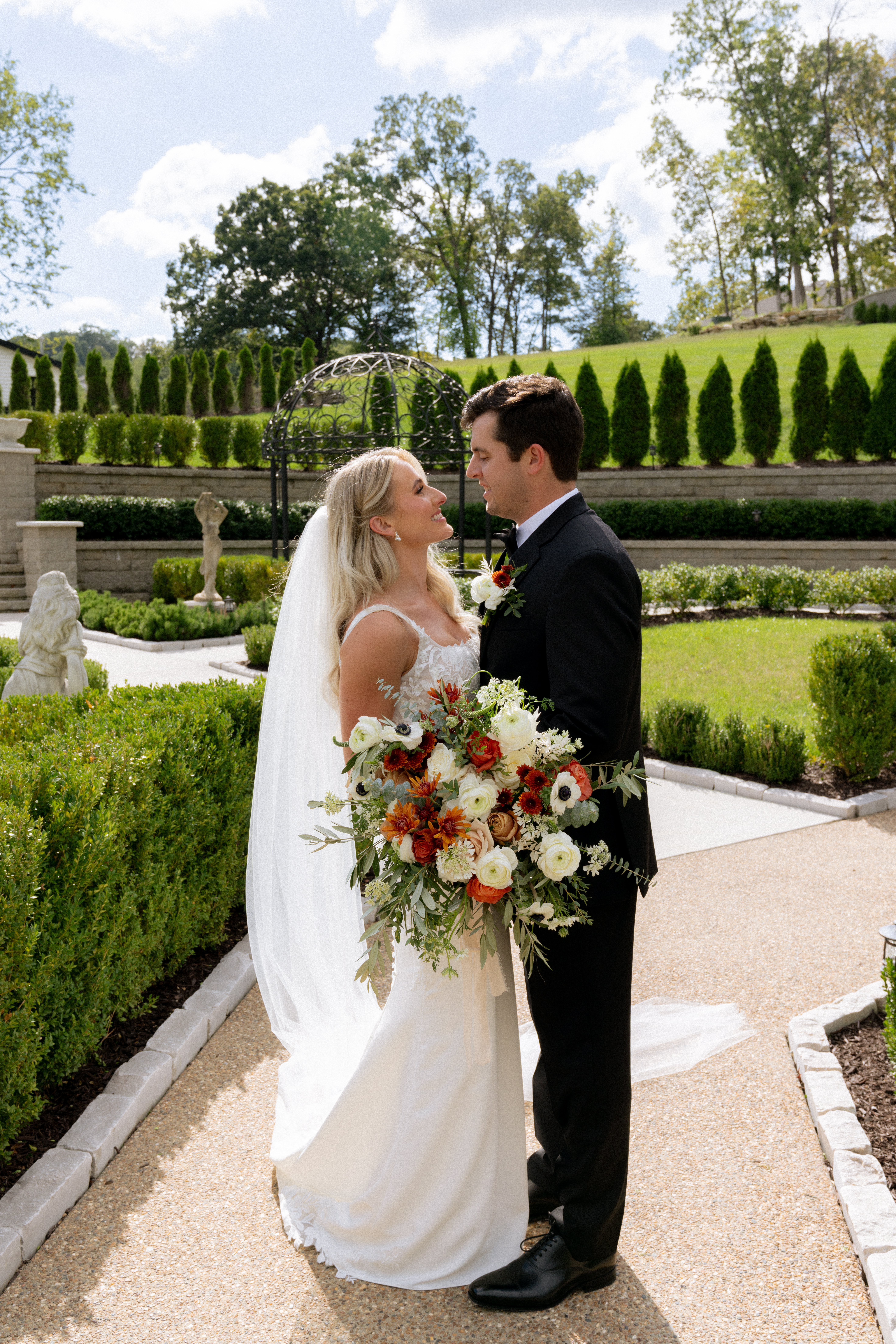 cute couple smiling at each other during their bridal portraits
