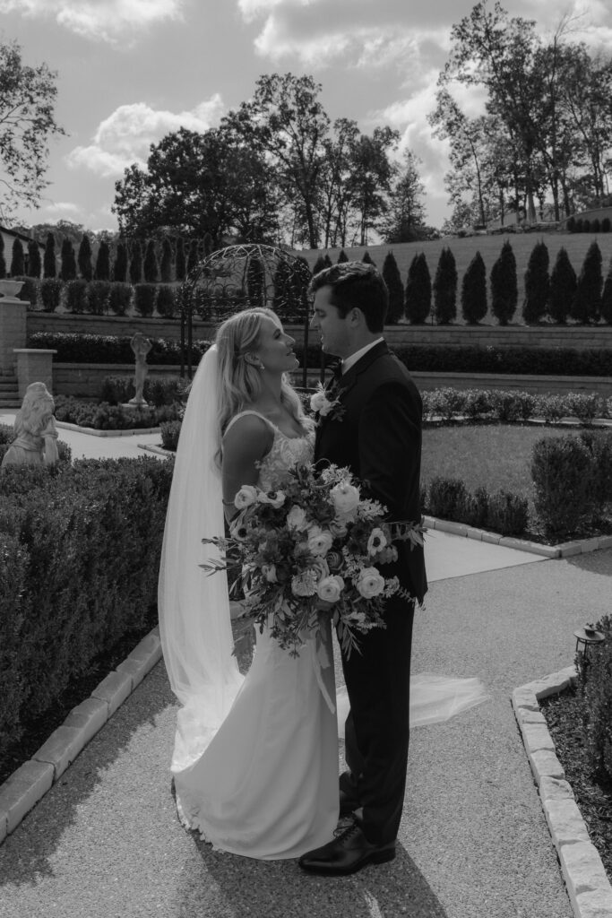 b&w portrait of the bride and groom smiling at each other 