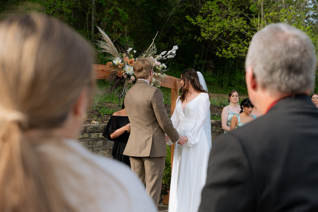 bride and groom holding hands at their wedding ceremony