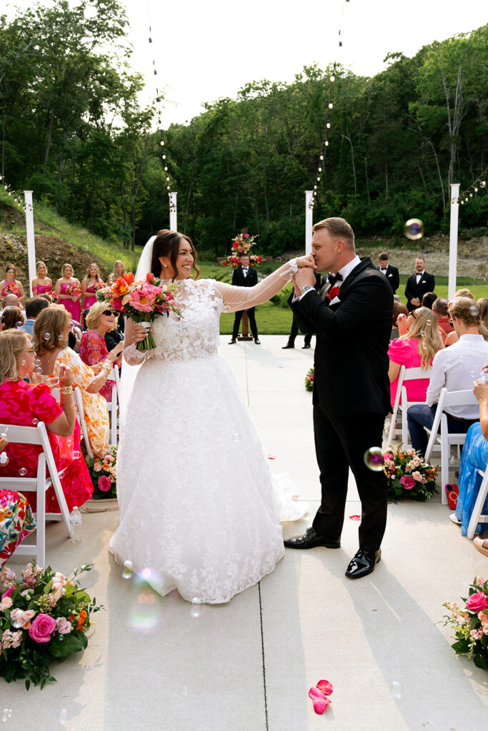 groom kissing the brides hand