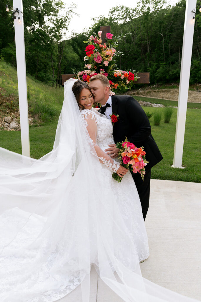 groom kissing the bride on the cheek
