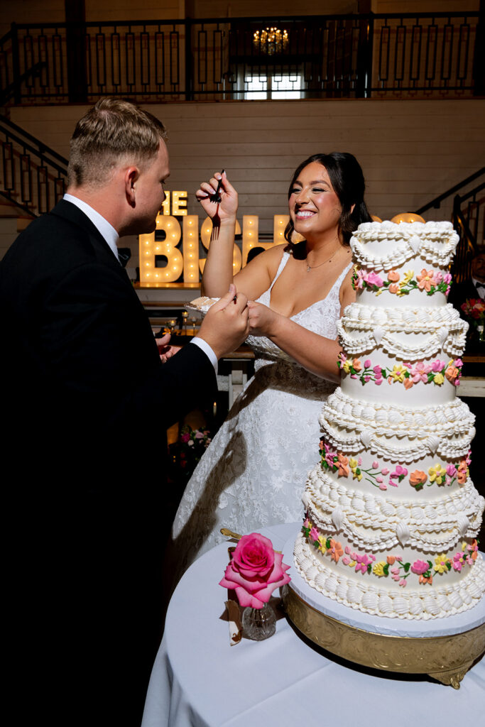 bride and groom cutting their wedding cake 
