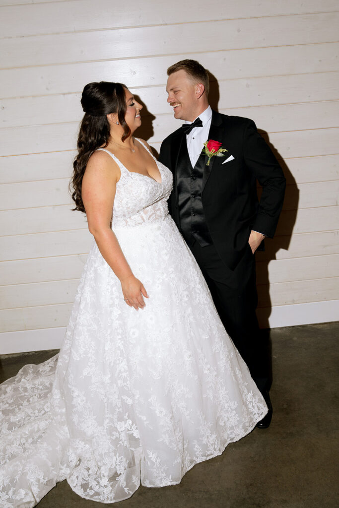 portrait of the bride and groom smiling at each other