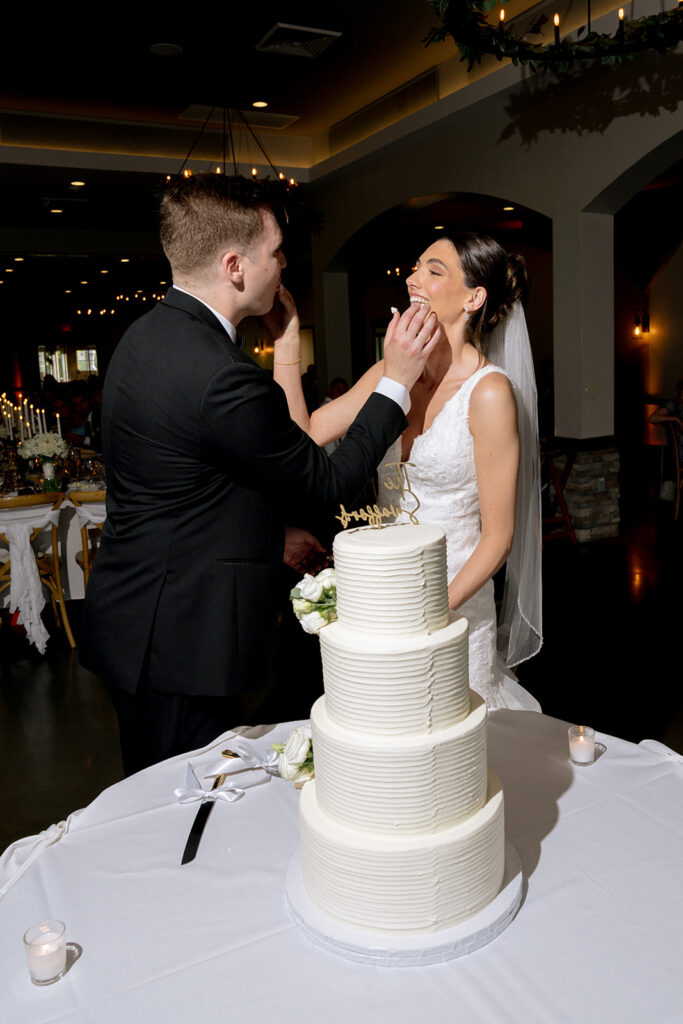 couple trying their wedding cake 