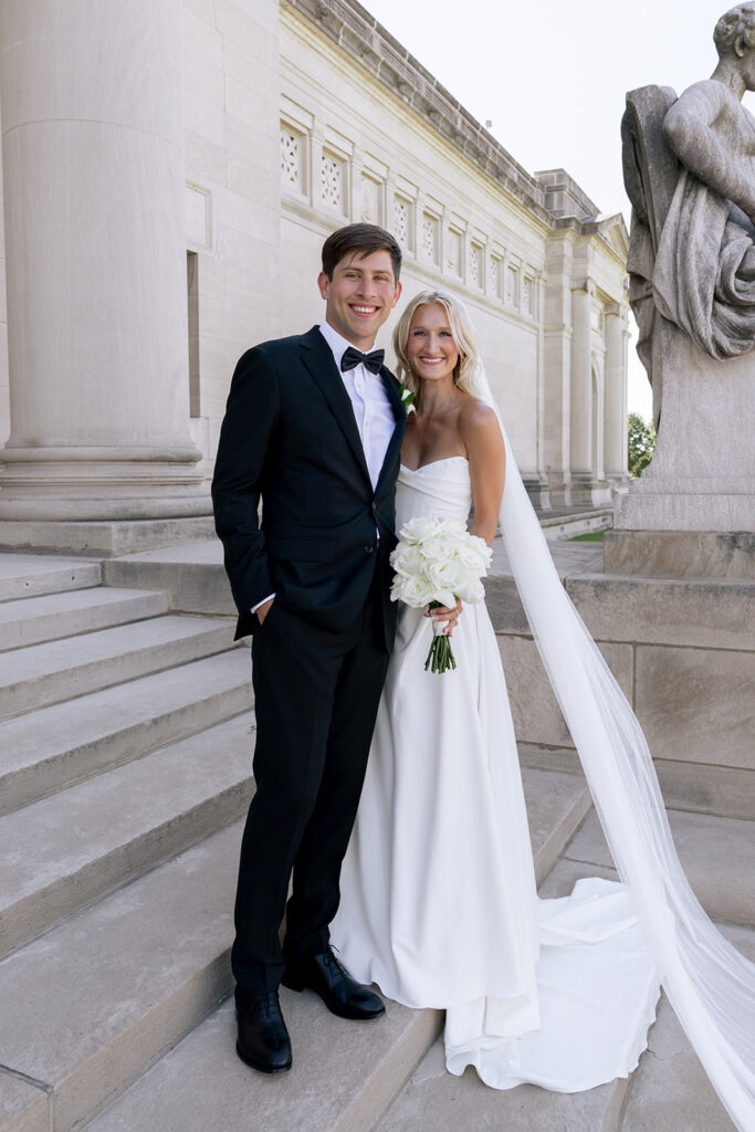 bride and groom smiling at the camera during their photoshoot