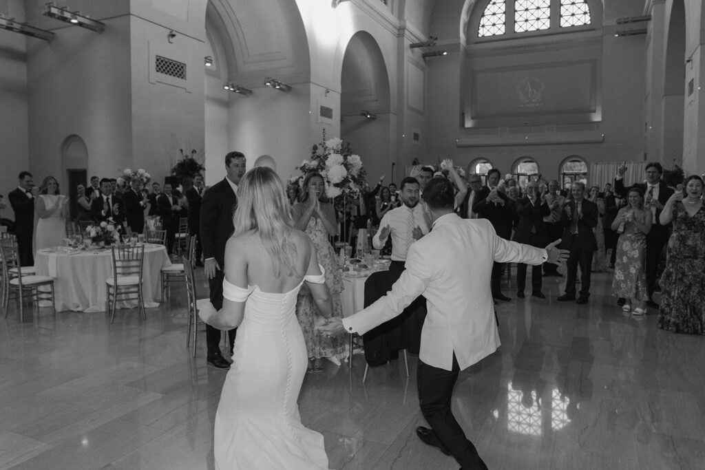 happy newly married couple arriving at their reception