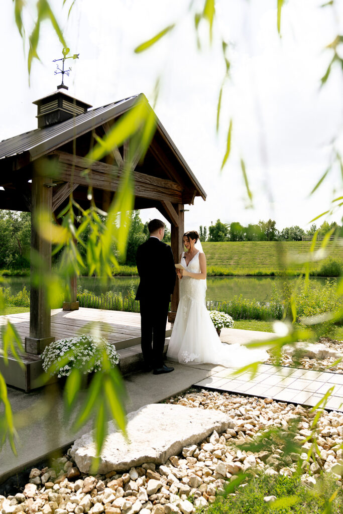 bride and groom reading their vows to each other privatly