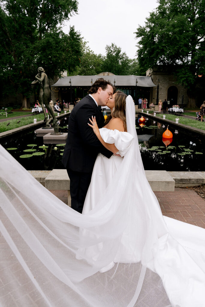 portrait of the newlyweds kissing at their reception