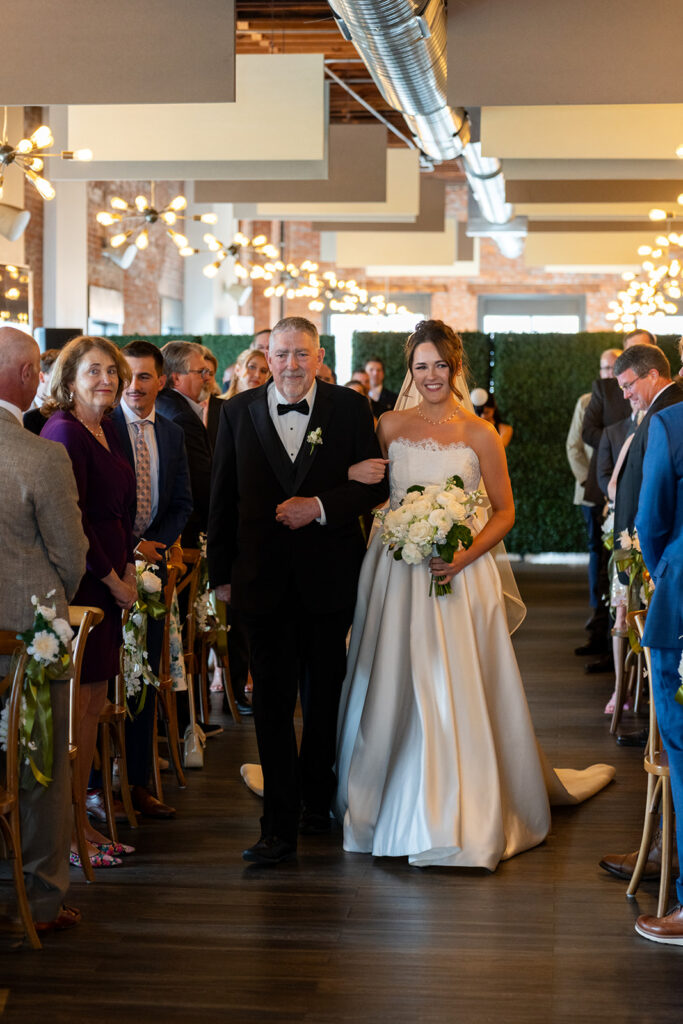 Stunning picture of the bride and her dad walking down the aisle