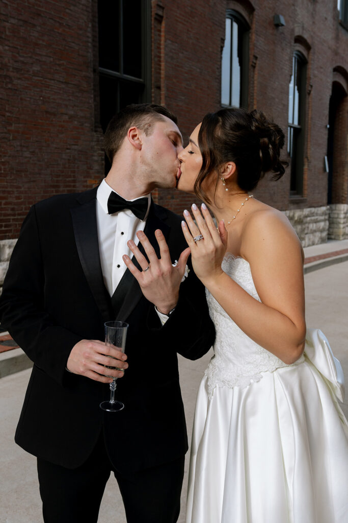 Portrait of the bride and groom showing their wedding rings