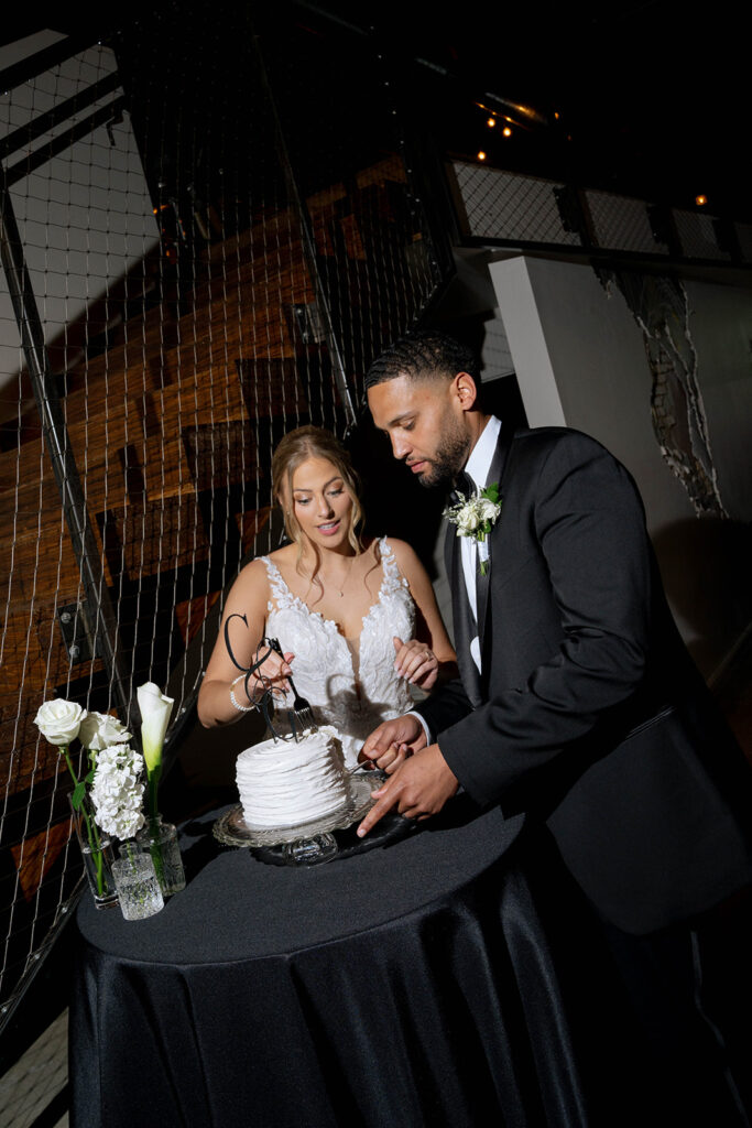 bride and groom cutting their wedding cake