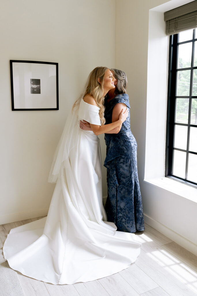 cute picture of the bride and her mom hugging