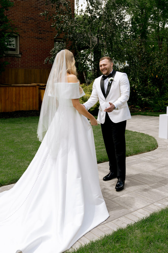 groom emotional seeing the bride in her wedding dress