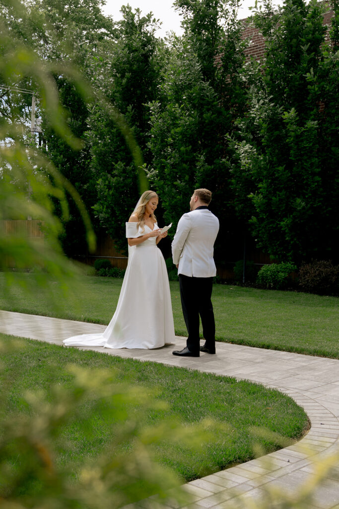 bride and groom reading their vows