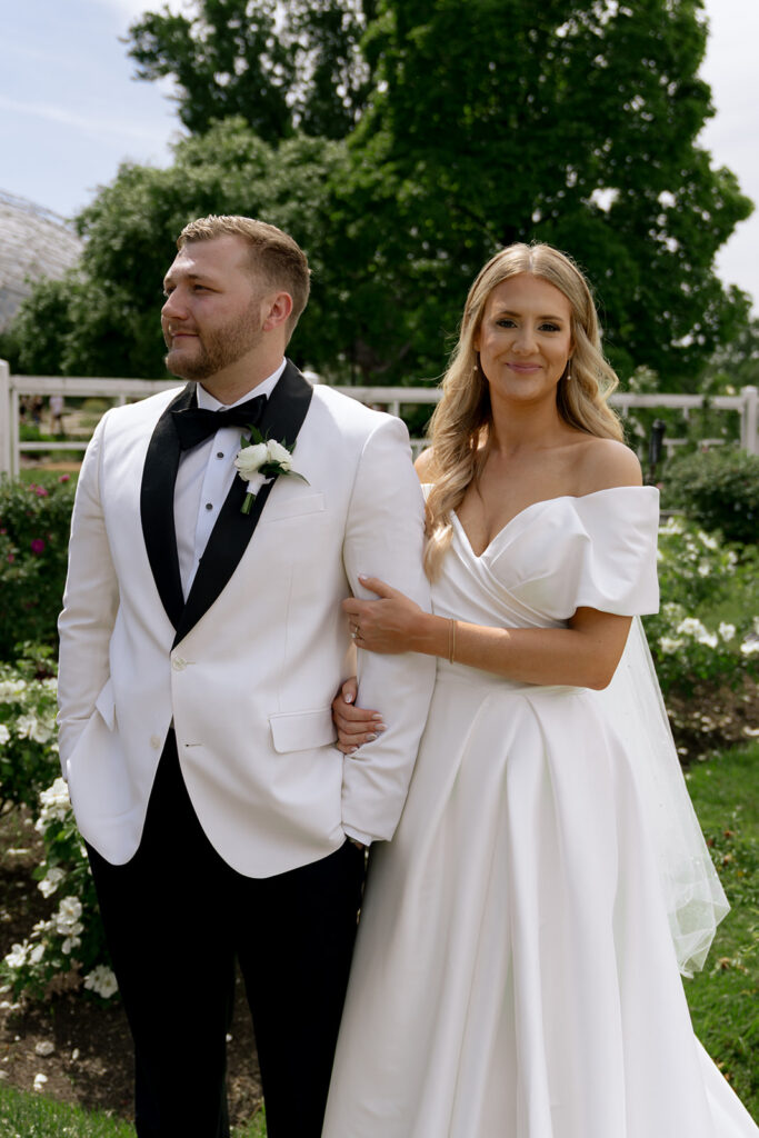bride and groom smiling a the camera during their bridal session