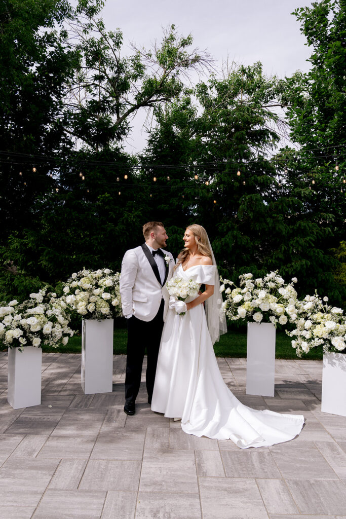portrait of the bride and groom smiling at each other