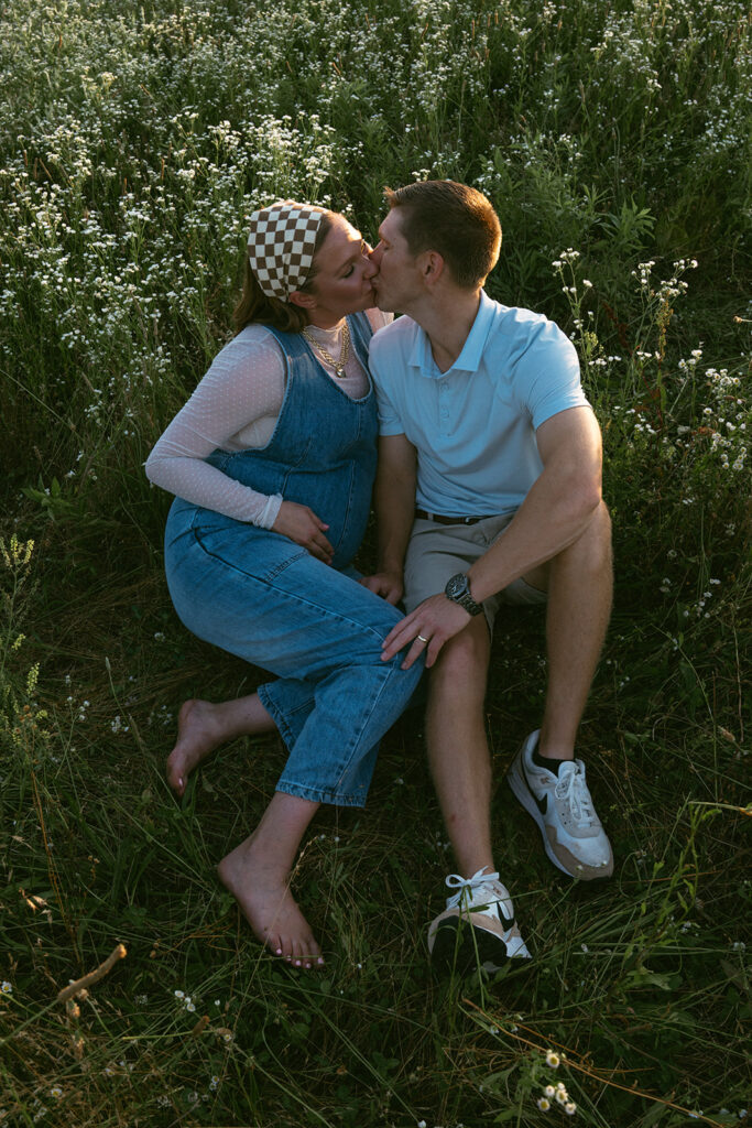 soon to be parents kissing during their golden hour session