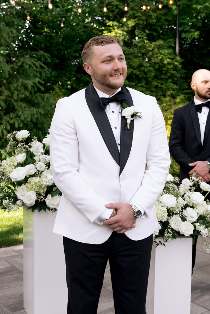 groom watching the bride walk down the aisle 