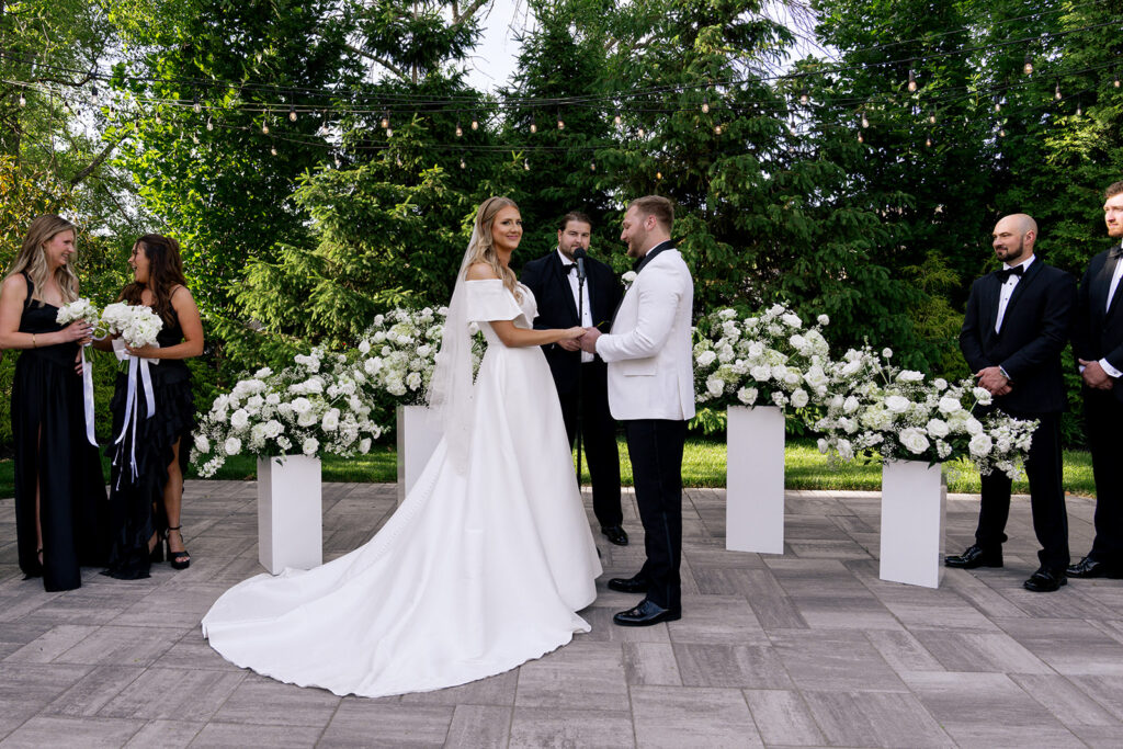 bride and groom holding hands during their ceremony