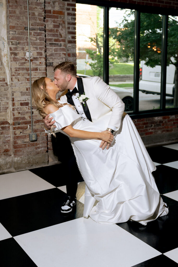 newlyweds kissing at their reception party