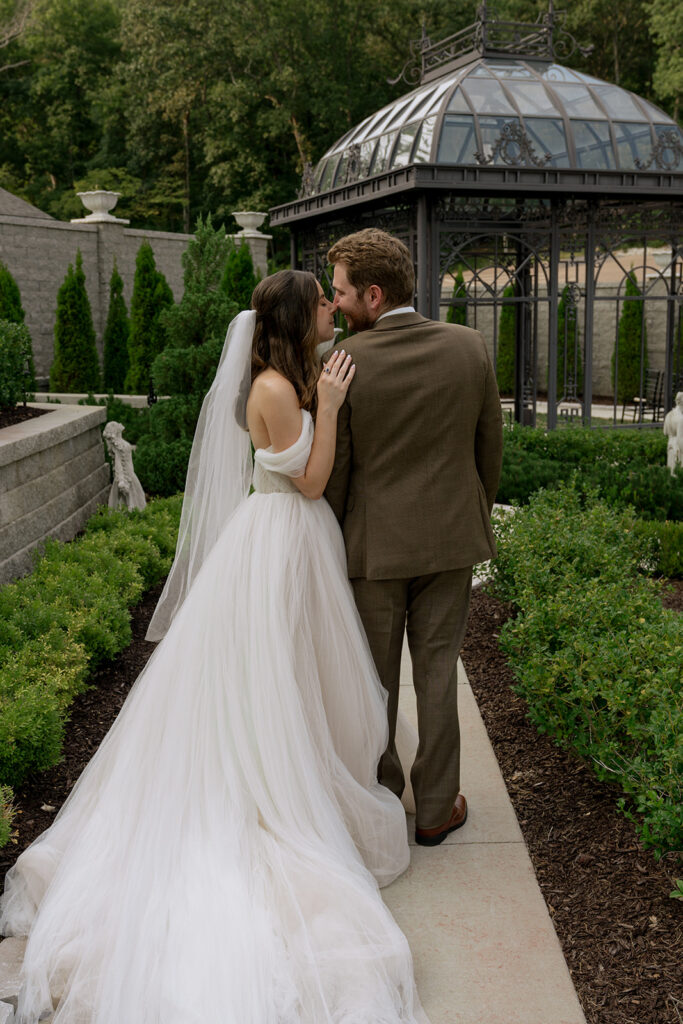 Groom, kissing the bride on the forehead